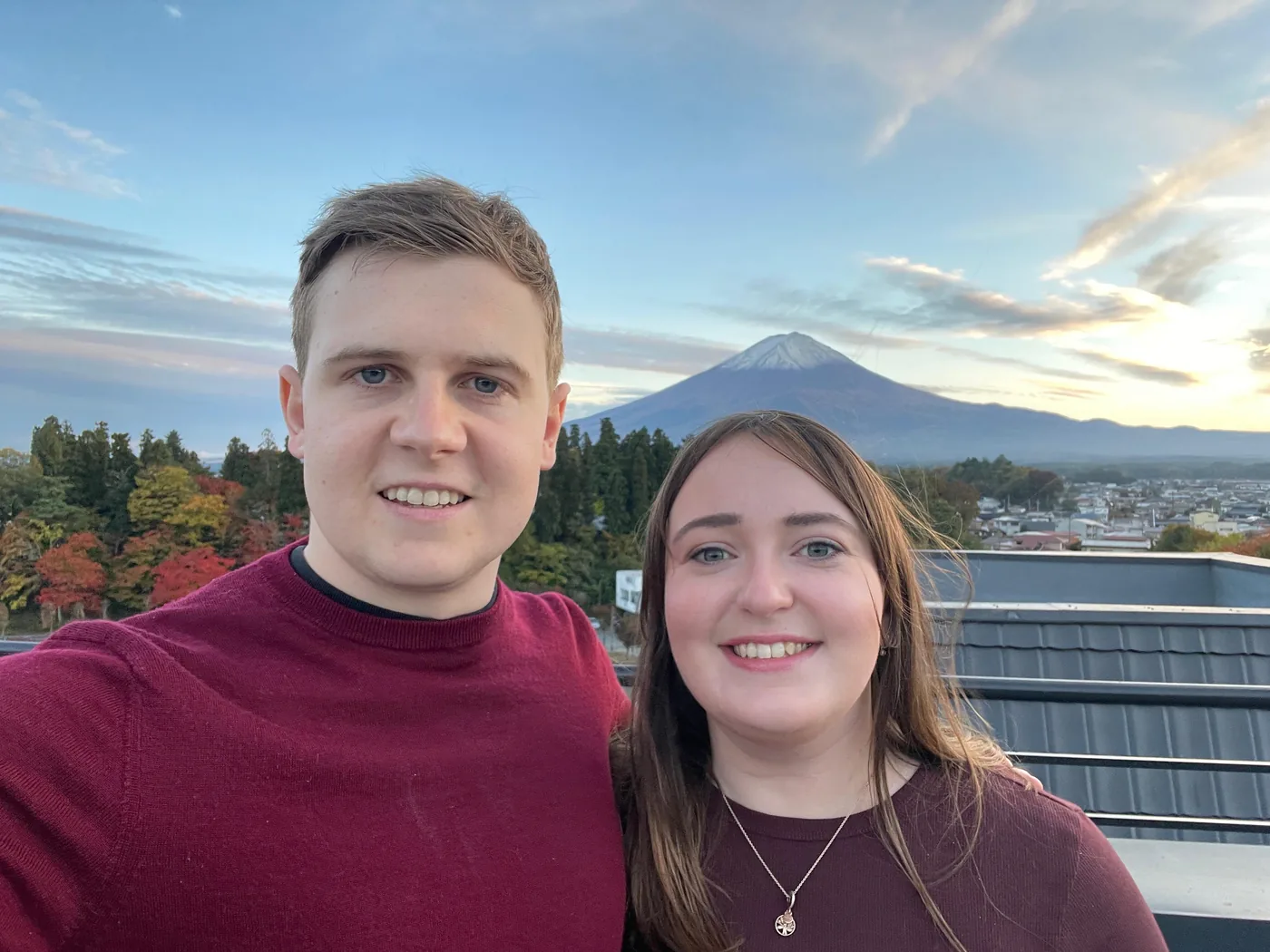 Jordana and Mark on a rooftop with Mount Fuji behind them